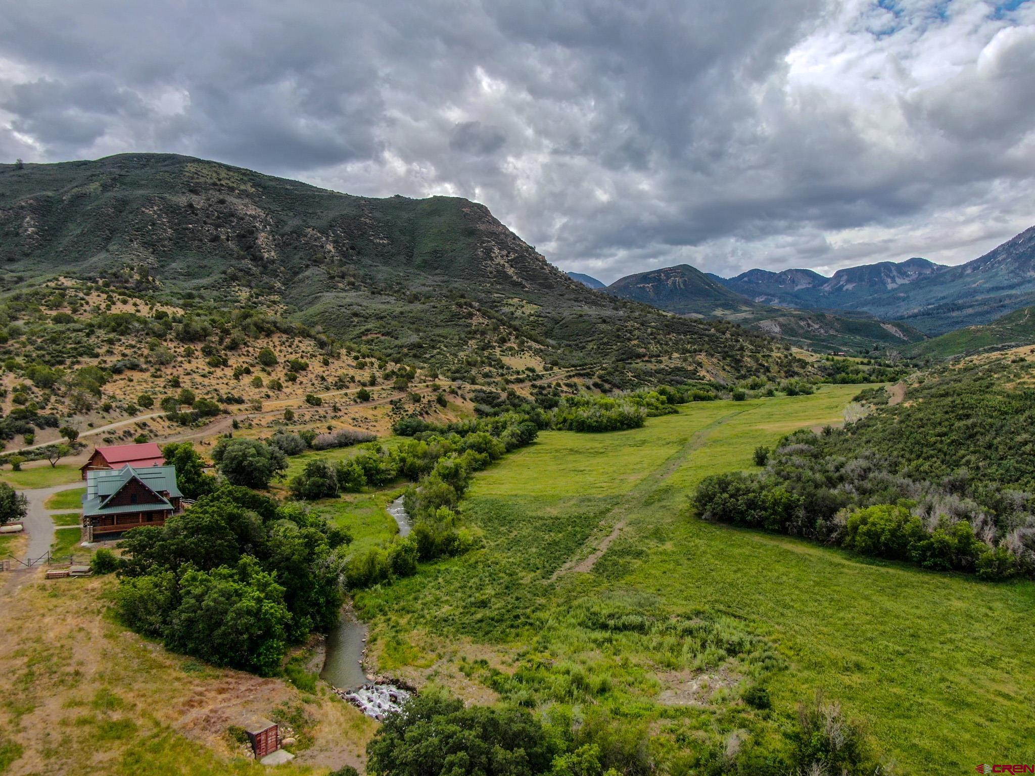 6300 Minnesota Creek Road Somerset, CO 81428 - Photo 11 of 22 a view of a lush green hillside and mountains