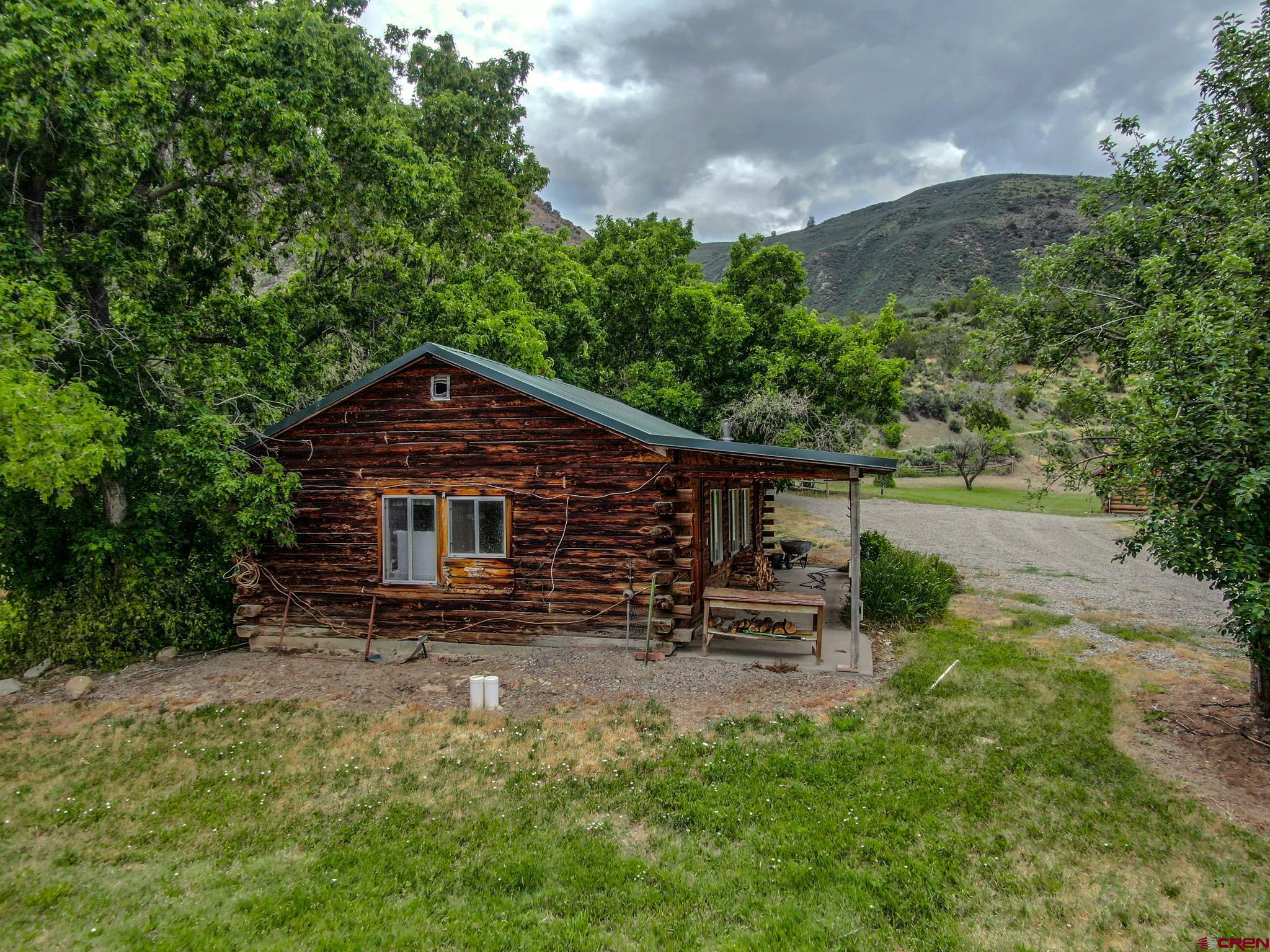 6300 Minnesota Creek Road Somerset, CO 81428 - Photo 16 of 22 a view of a house with backyard sitting area and garden
