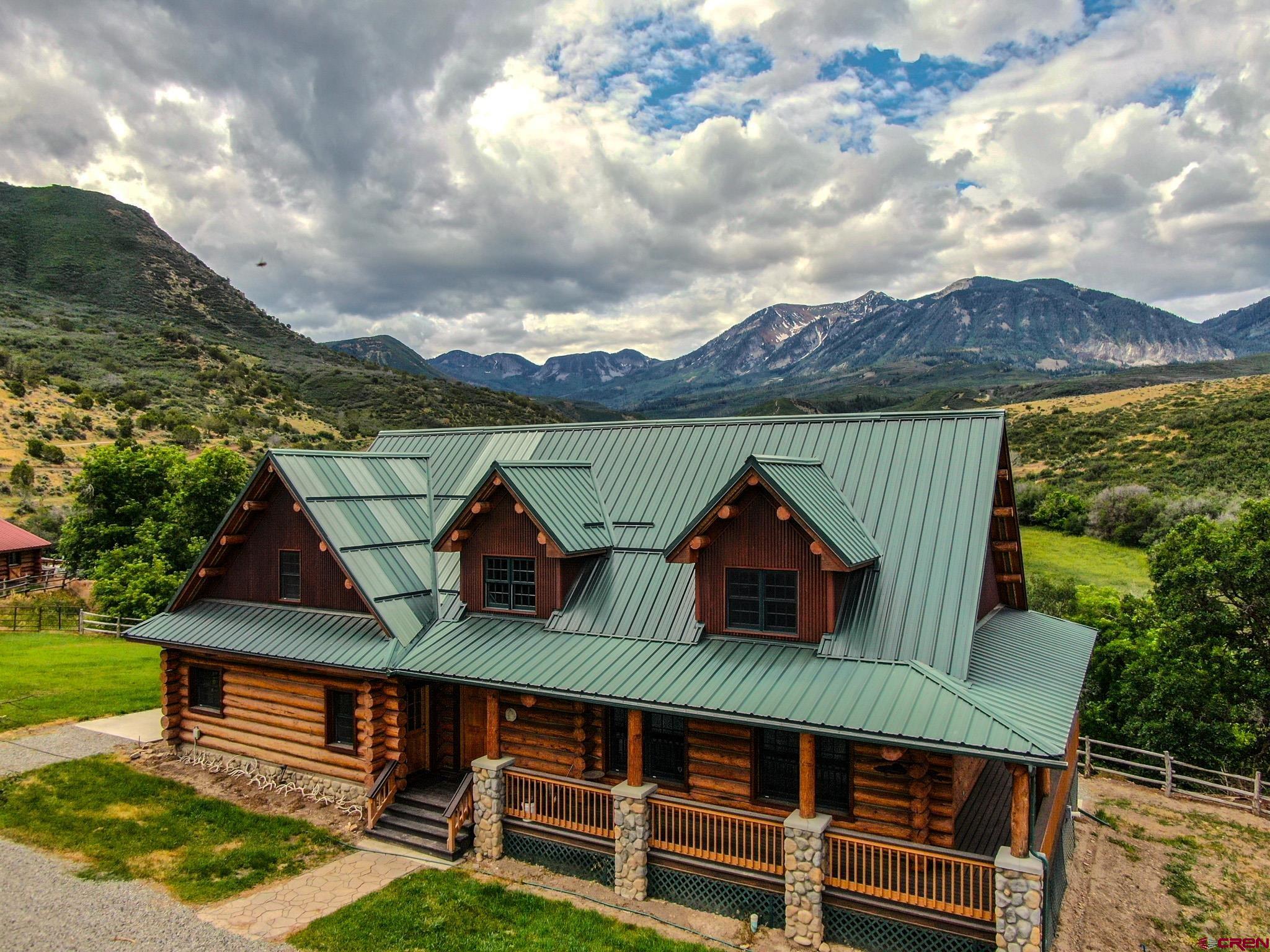 6300 Minnesota Creek Road Somerset, CO 81428 - Photo 2 of 22 a view of a house with wooden deck and furniture