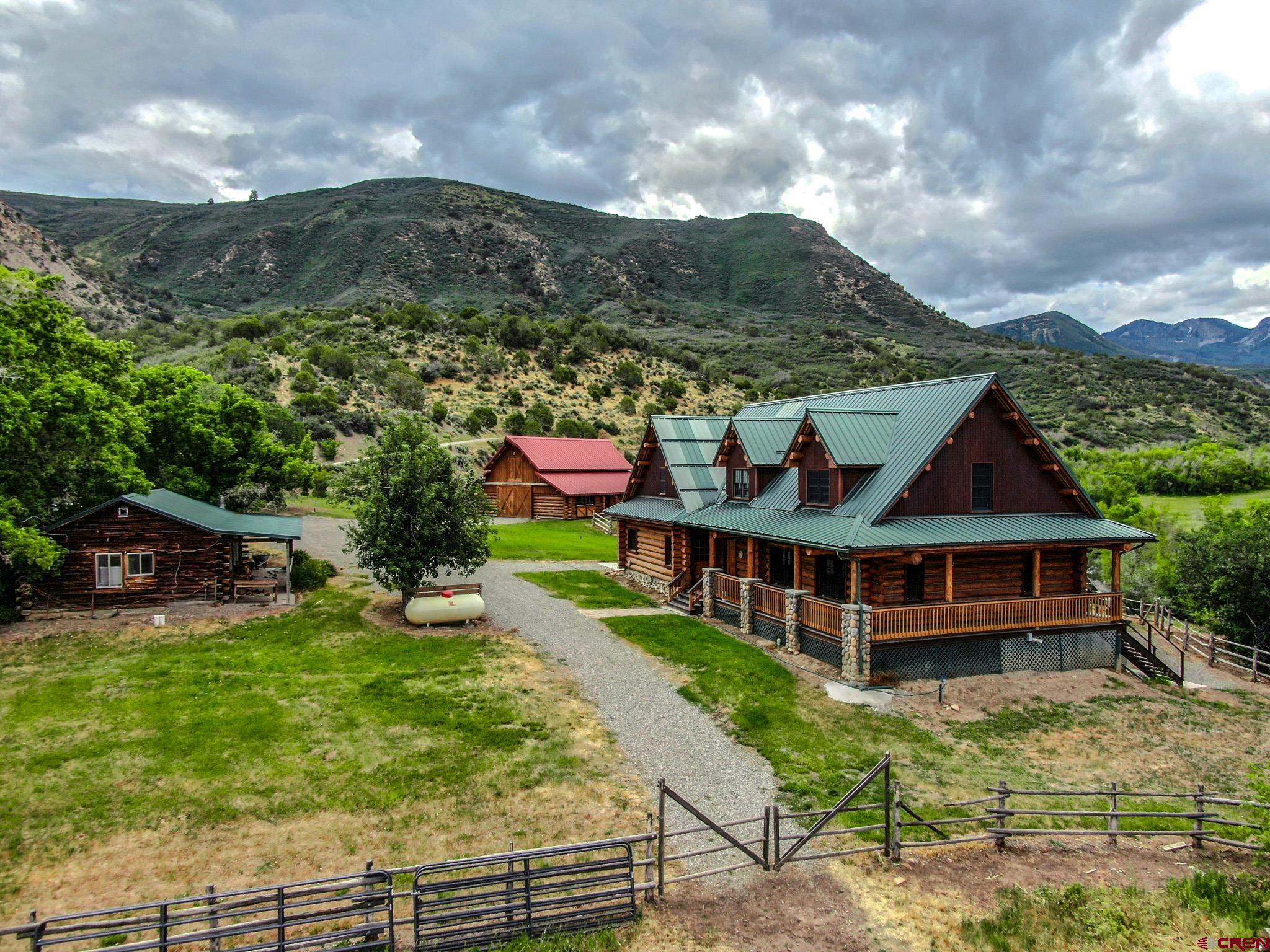 6300 Minnesota Creek Road Somerset, CO 81428 - Photo 3 of 22 a view of a house with a big yard and large trees