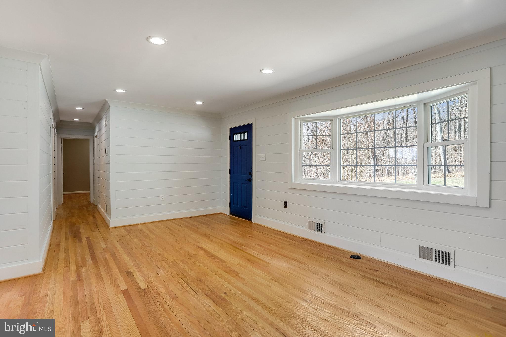 6343 Yeagertown Road New Market, MD 21774 - Photo 12 of 58 a view of an empty room with wooden floor and a window