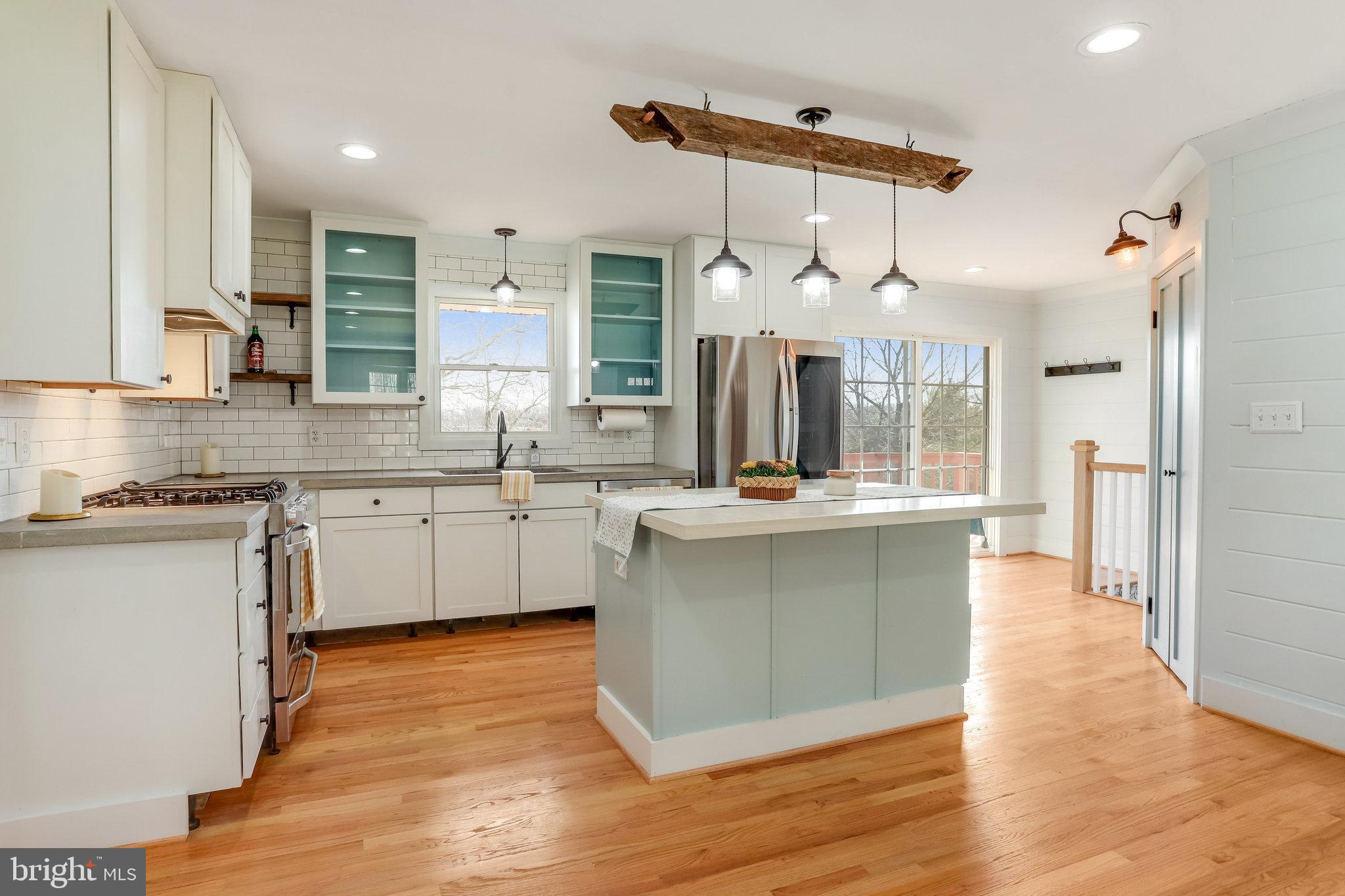 6343 Yeagertown Road New Market, MD 21774 - Photo 14 of 58 a kitchen with a sink cabinets stainless steel appliances and a window