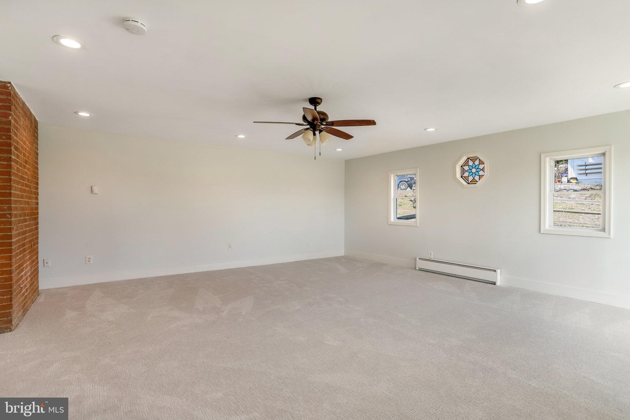 6343 Yeagertown Road New Market, MD 21774 - Photo 24 of 58 an empty room with windows and ceiling fan