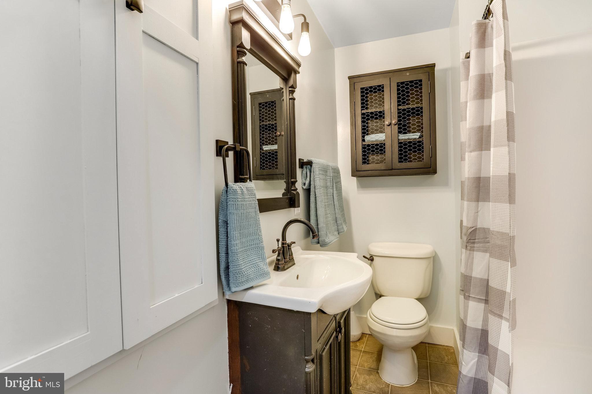 6343 Yeagertown Road New Market, MD 21774 - Photo 27 of 58 a bathroom with a sink a toilet and shower
