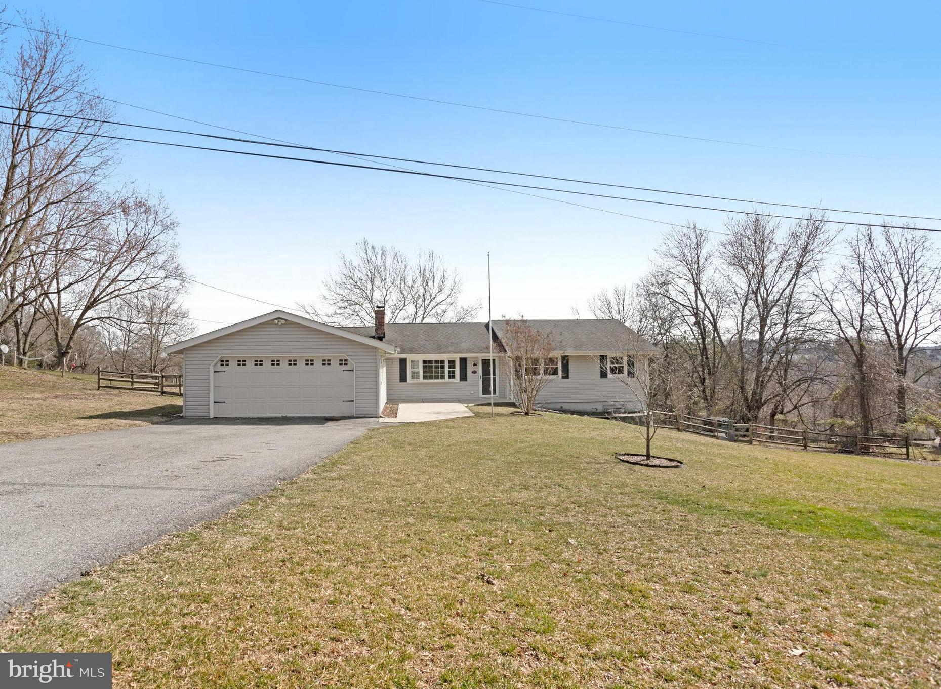 6343 Yeagertown Road New Market, MD 21774 - Photo 57 of 58 a front view of a house with a yard and garage
