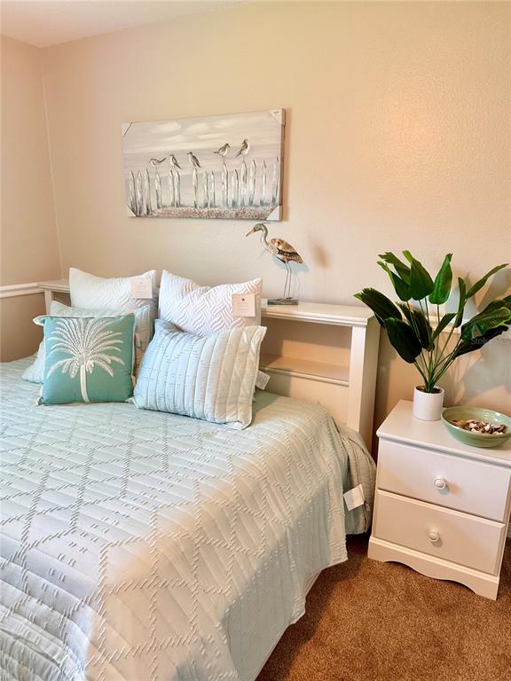 7 Lancaster Lane Palm Coast, FL 32137 - Photo 11 of 67 a bedroom with a bed and a potted plant on the dresser