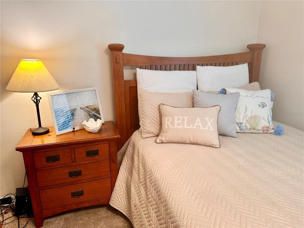 7 Lancaster Lane Palm Coast, FL 32137 - Photo 12 of 67 a bed room with a bed and a lamp