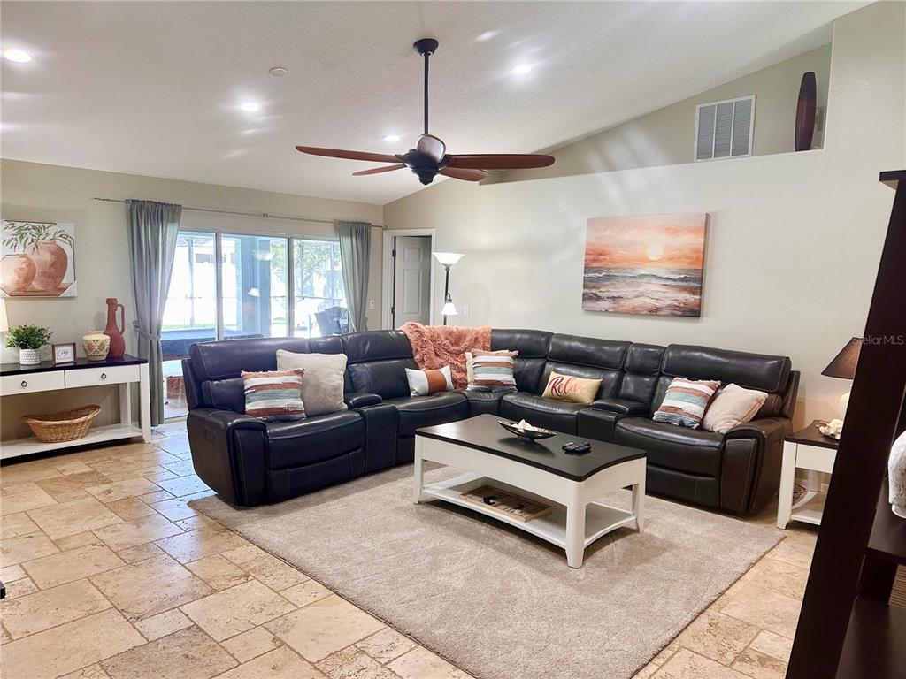 7 Lancaster Lane Palm Coast, FL 32137 - Photo 14 of 67 a living room with furniture a ceiling fan and a rug
