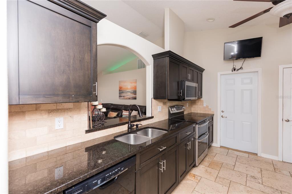 7 Lancaster Lane Palm Coast, FL 32137 - Photo 20 of 67 a kitchen with a sink and a microwave