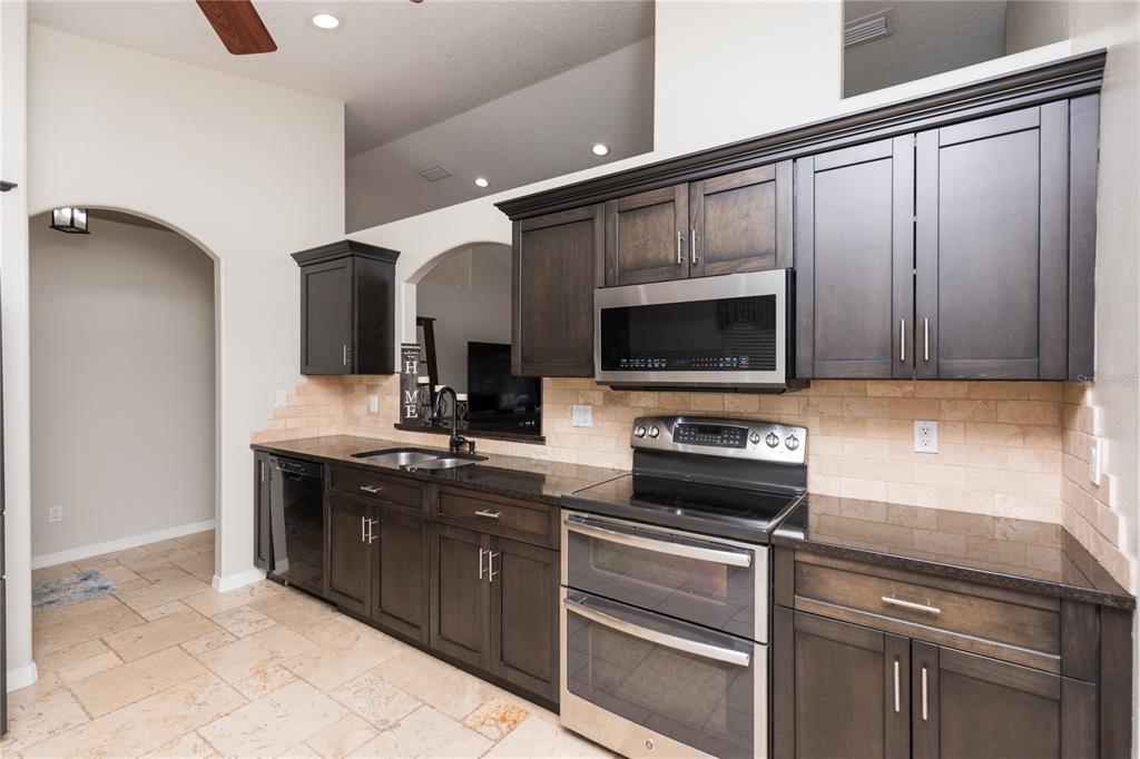 7 Lancaster Lane Palm Coast, FL 32137 - Photo 22 of 67 a kitchen with stainless steel appliances a stove and a sink