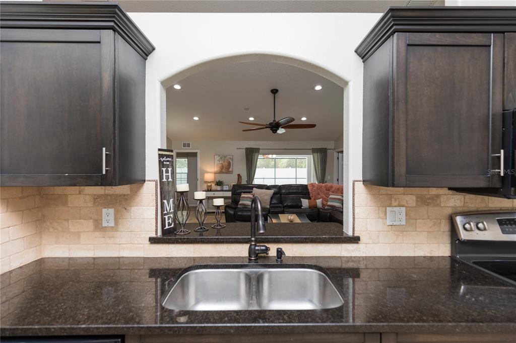 7 Lancaster Lane Palm Coast, FL 32137 - Photo 23 of 67 a kitchen with a sink and a mirror