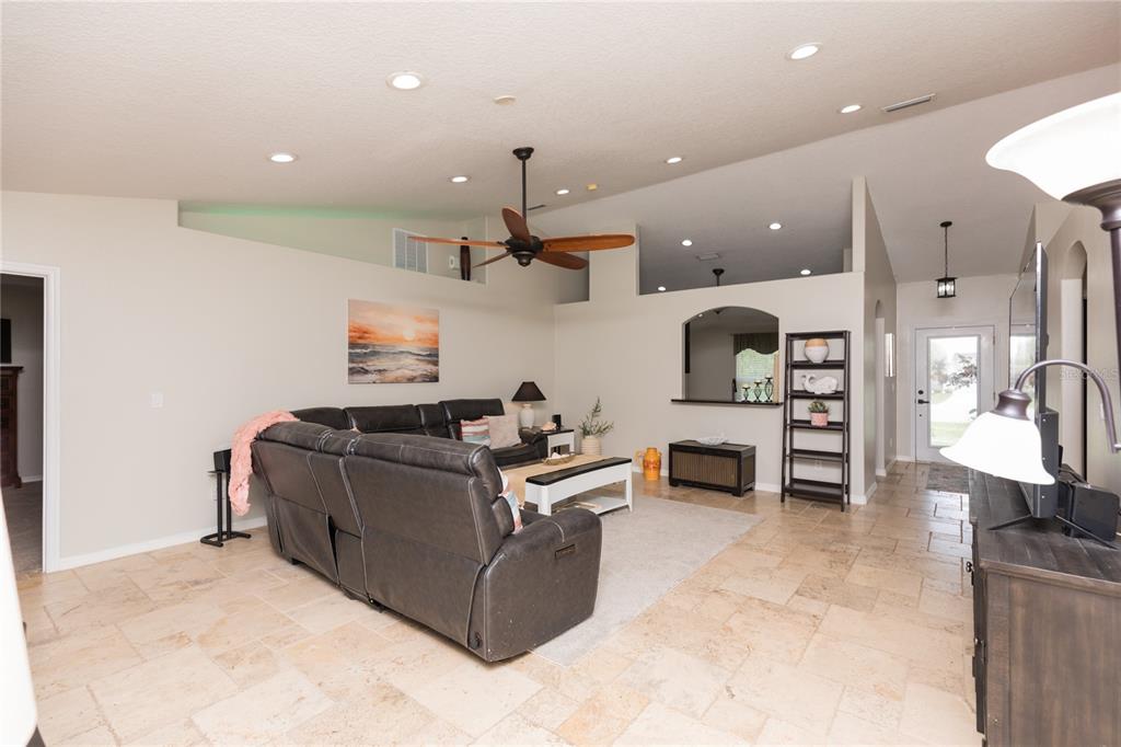 7 Lancaster Lane Palm Coast, FL 32137 - Photo 29 of 67 a living room with furniture and a fireplace