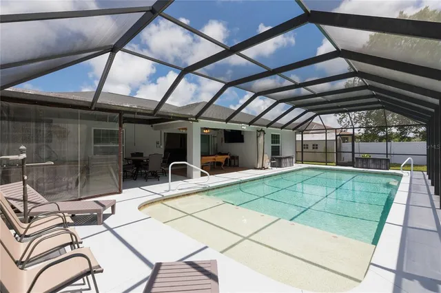 a bedroom with a bed a mirror and a flat screen tv