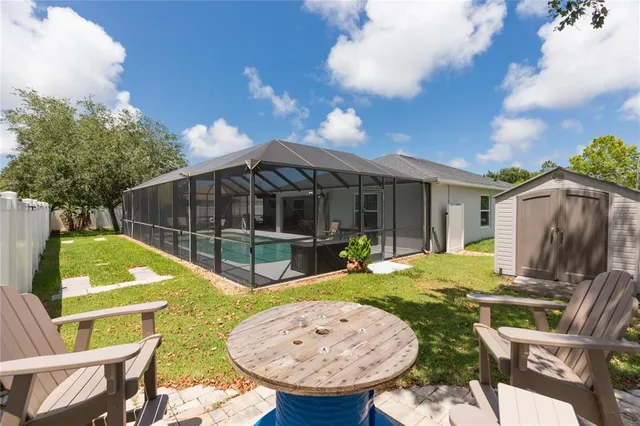 a spacious bedroom with a bed and a chandelier