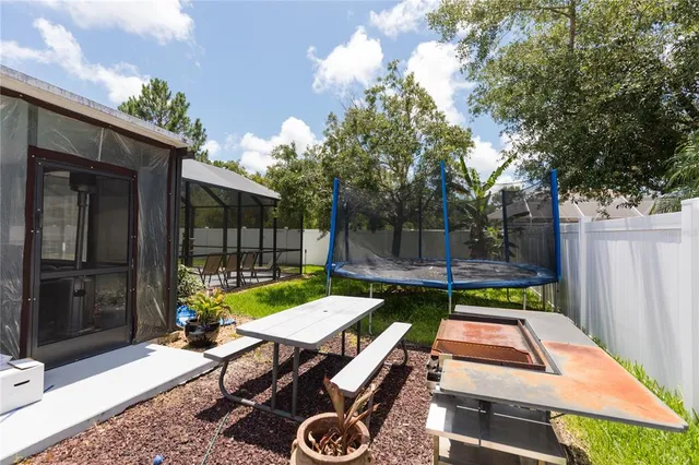 a bedroom with a bed and a flat tv screen on dresser