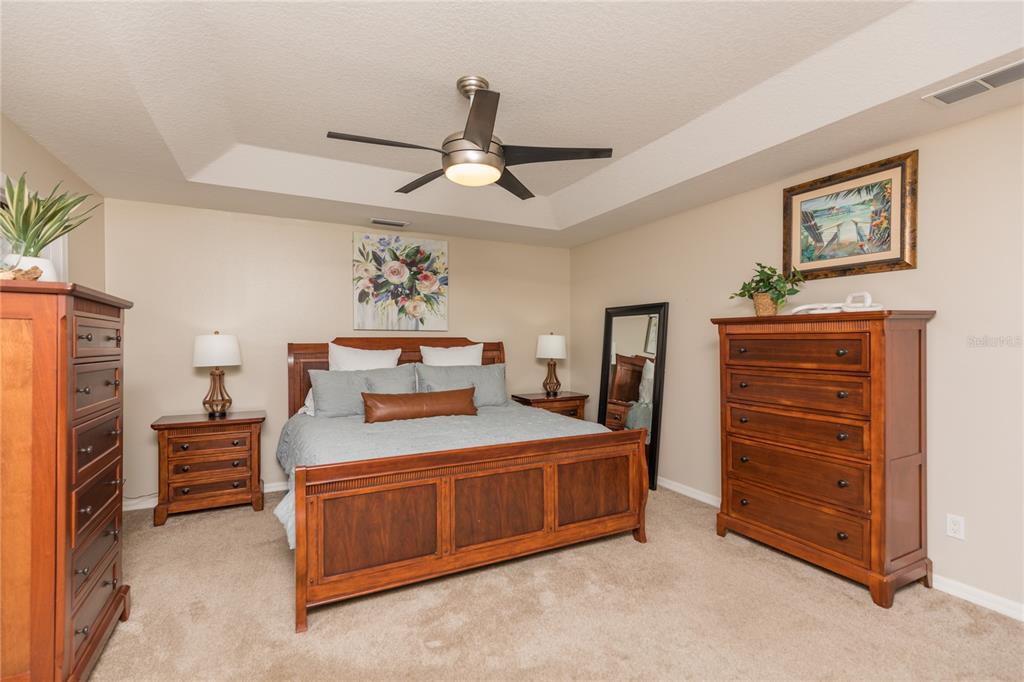 7 Lancaster Lane Palm Coast, FL 32137 - Photo 51 of 67 a bedroom with a bed and a chandelier