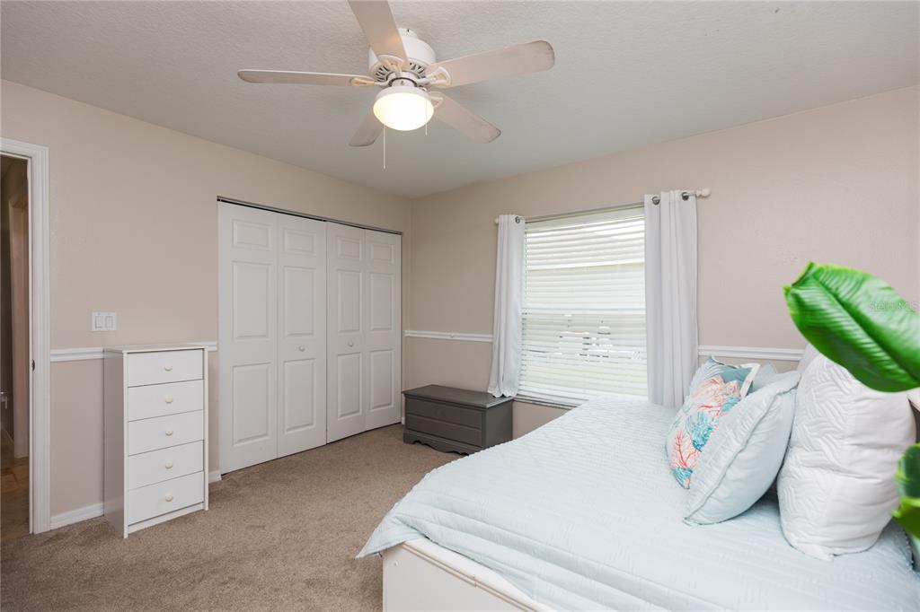 7 Lancaster Lane Palm Coast, FL 32137 - Photo 56 of 67 a bedroom with a bed and a chandelier