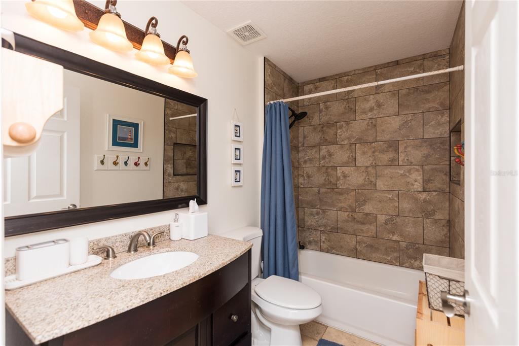 7 Lancaster Lane Palm Coast, FL 32137 - Photo 60 of 67 a bathroom with a sink a toilet and shower
