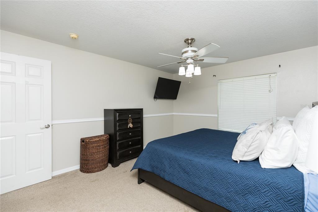 7 Lancaster Lane Palm Coast, FL 32137 - Photo 61 of 67 a bedroom with bed and a chandelier