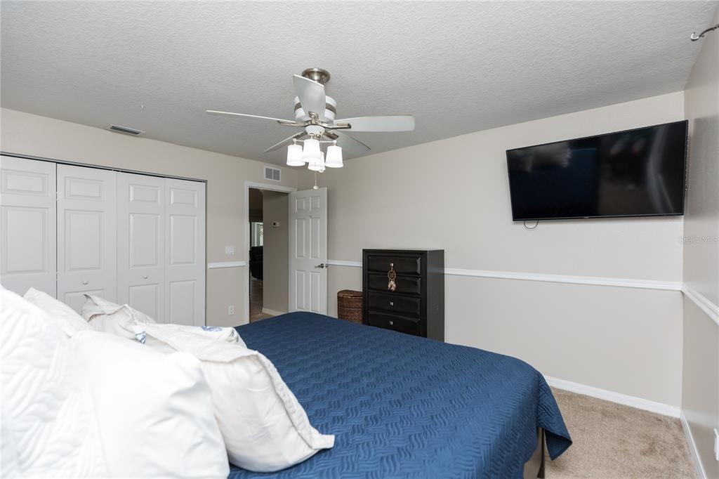 7 Lancaster Lane Palm Coast, FL 32137 - Photo 64 of 67 a bedroom with a bed and a flat screen tv