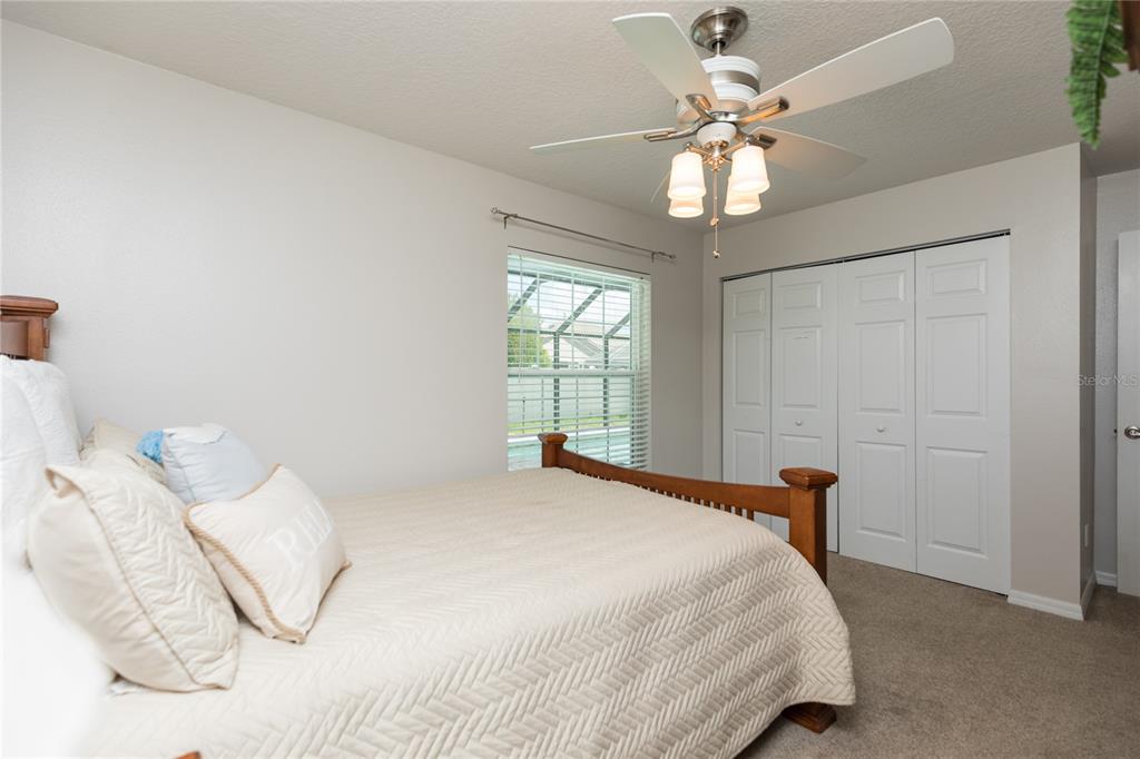 7 Lancaster Lane Palm Coast, FL 32137 - Photo 67 of 67 a bedroom with a bed and a chandelier