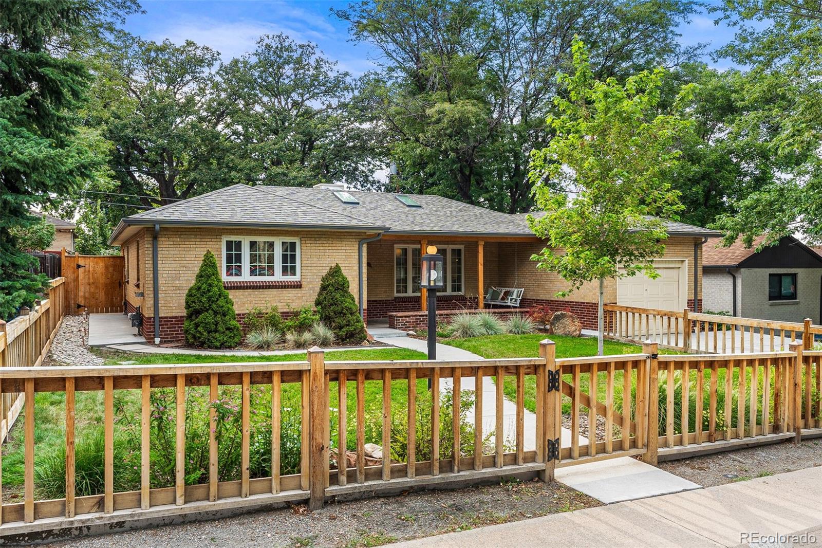 3715 Fenton Street Wheat Ridge, CO 80212 - Photo 1 of 13 a front view of a house with a yard