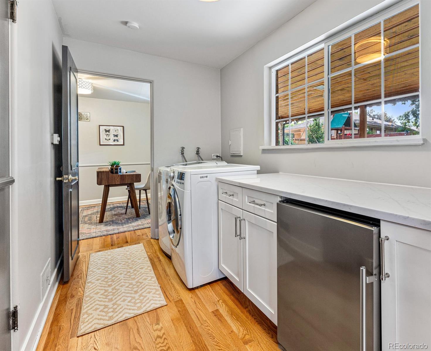 3715 Fenton Street Wheat Ridge, CO 80212 - Photo 11 of 13 a kitchen with stainless steel appliances granite countertop a stove a sink and a microwave