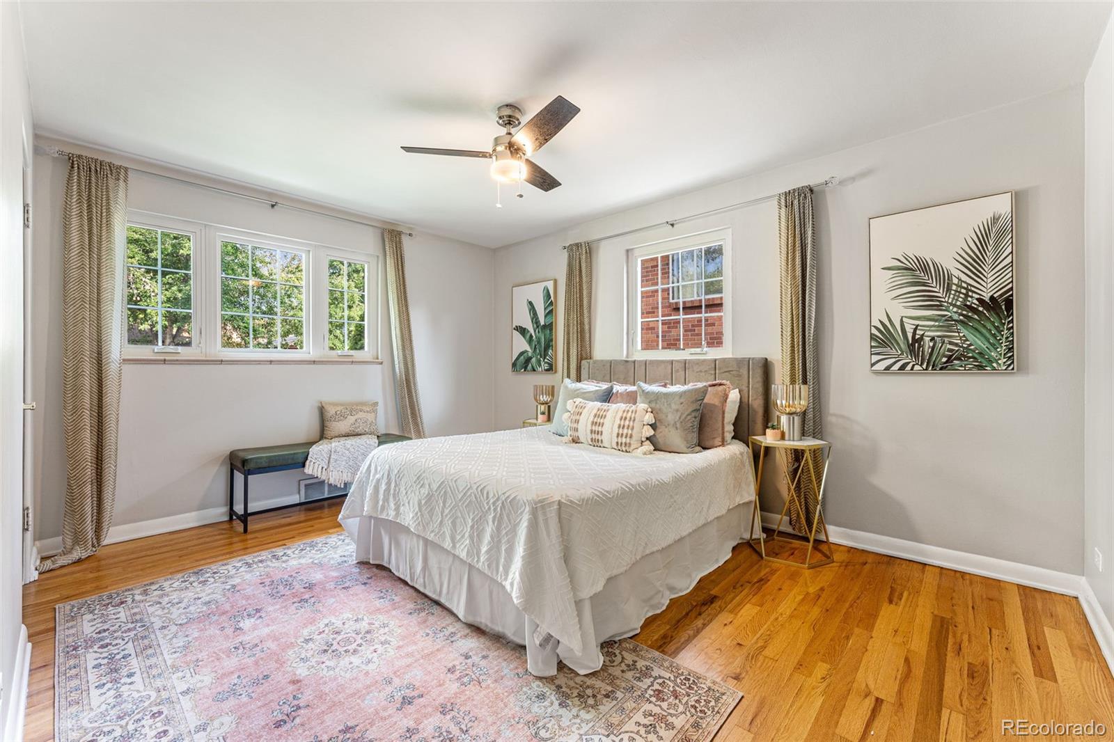 3715 Fenton Street Wheat Ridge, CO 80212 - Photo 6 of 13 a bedroom with a large bed and a chandelier