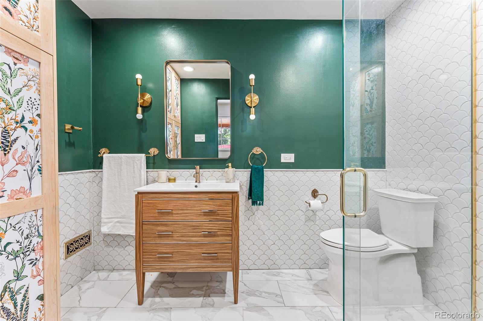 3715 Fenton Street Wheat Ridge, CO 80212 - Photo 10 of 13 a bathroom with a sink a toilet and mirror