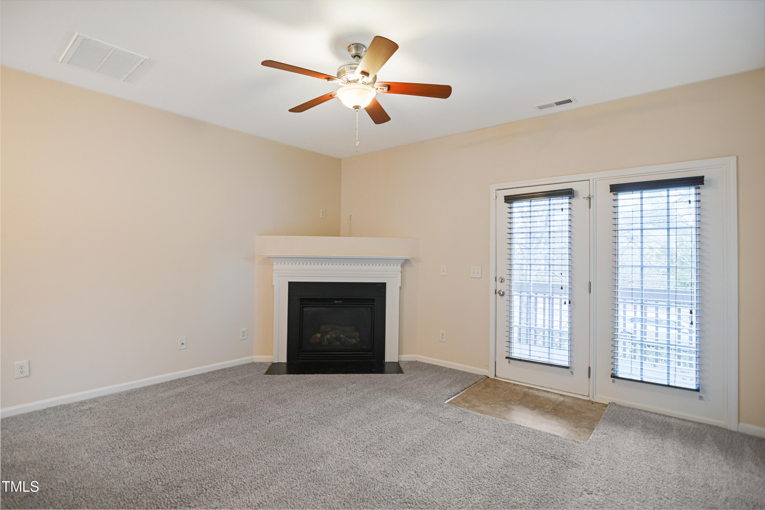 1673 Snow Mass Way Durham, NC 27713 - Photo 3 of 20 a view of an empty room with chandelier fan and fire place