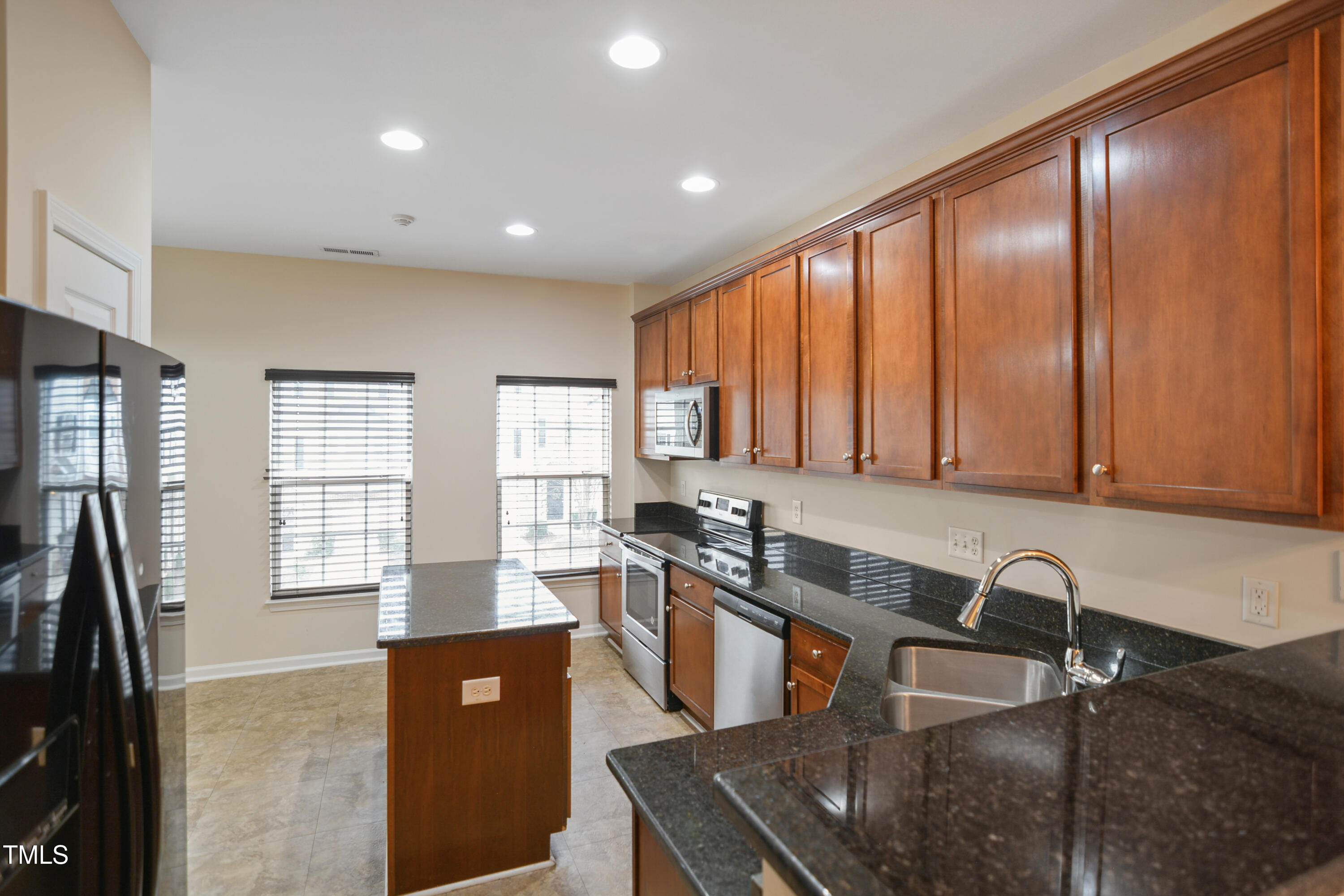 1673 Snow Mass Way Durham, NC 27713 - Photo 6 of 20 a kitchen with stainless steel appliances granite countertop a sink a stove and a refrigerator
