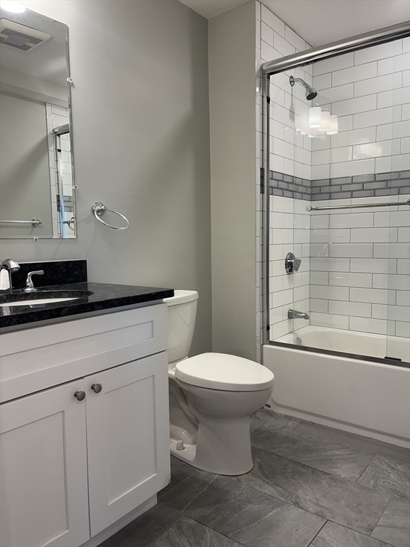 45 Spring Street, Unit 6 Boston, MA 02132 - Photo 9 of 17 a bathroom with a toilet a sink and shower