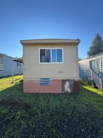 a view of a house with a backyard