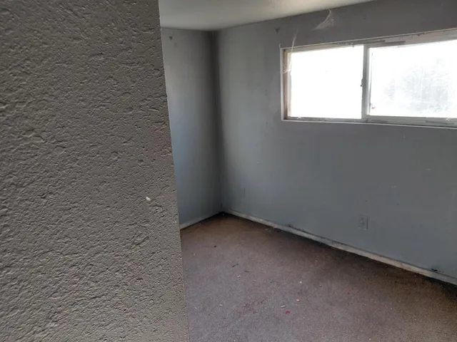 a view of an empty room with a window