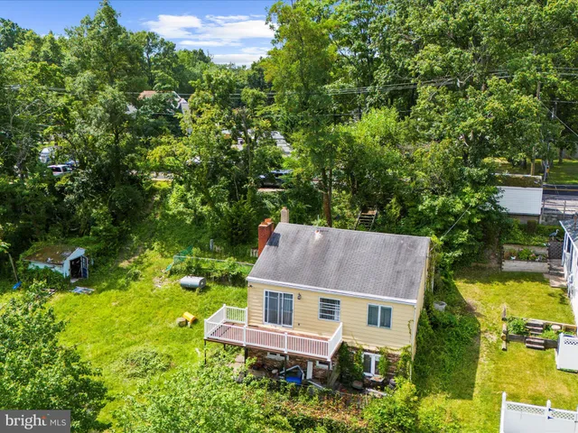 an aerial view of a house with swimming pool garden and patio