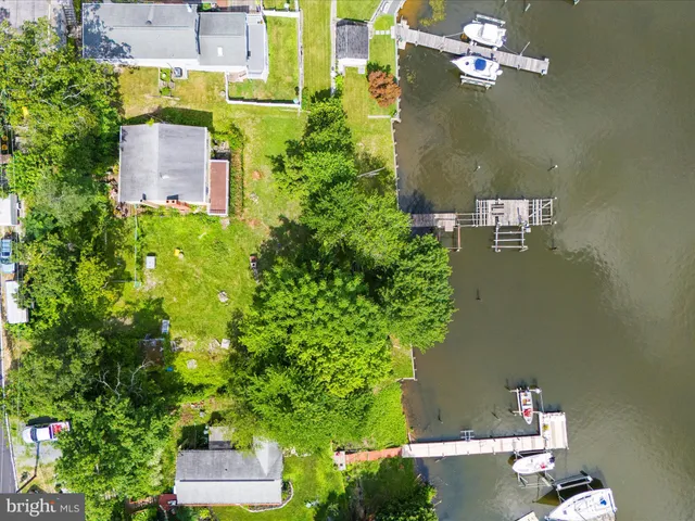 an aerial view of a house with a yard basket ball court and outdoor seating