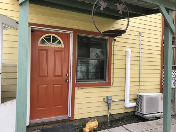 a front view of a house with red door
