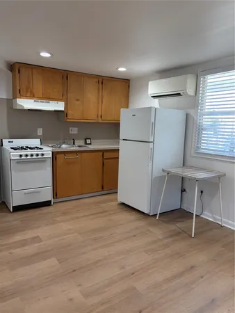 a kitchen with a refrigerator and a stove top oven