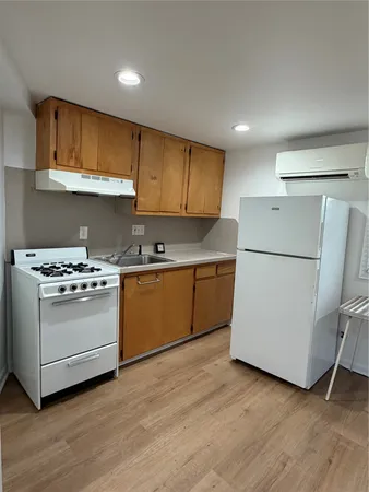 a kitchen with a white stove top oven and white refrigerator