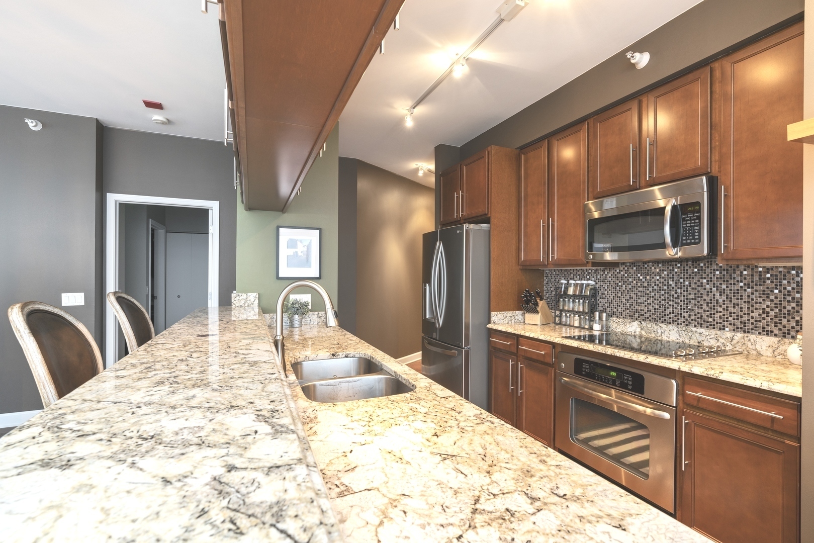 1629 South Prairie Avenue, Unit 2906 Chicago, IL 60616 - Photo 6 of 21 a kitchen with stainless steel appliances kitchen island granite countertop a sink refrigerator stove and microwave