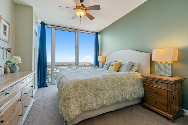 1629 South Prairie Avenue, Unit 2906 Chicago, IL 60616 - Photo 8 of 21 a bedroom with a bed and a chandelier