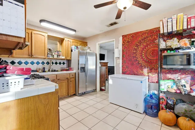 a kitchen with refrigerator and cabinets