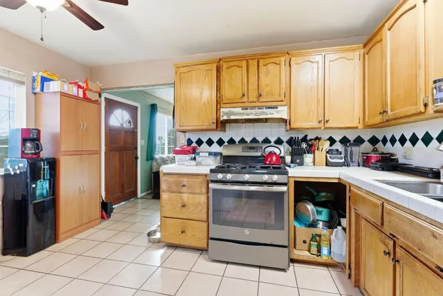 a kitchen with stainless steel appliances granite countertop a refrigerator sink and cabinets