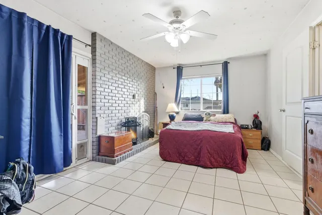 a spacious bedroom with a bed and window