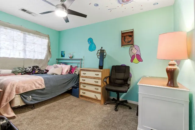 a bed room with furniture and a window