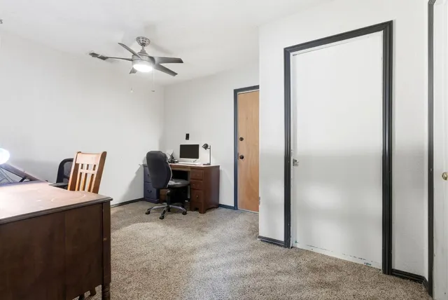 a view of a workspace with furniture and a bedroom