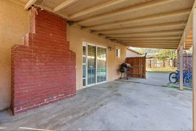 a view of a patio with table and chairs and potted plants