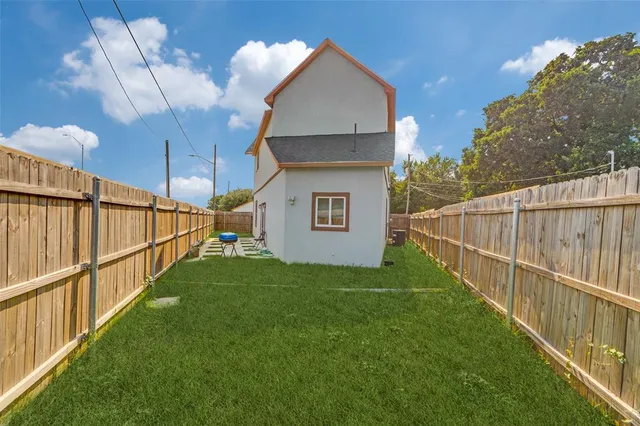 a view of a backyard with wooden fence