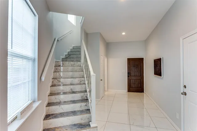 a view of entryway with wooden floor and stairs