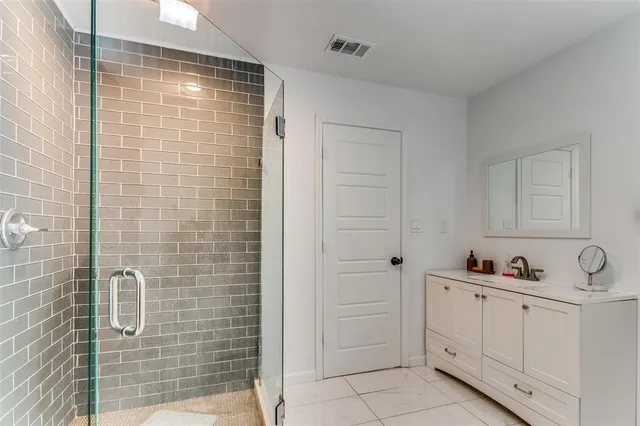 a bathroom with a shower and a sink
